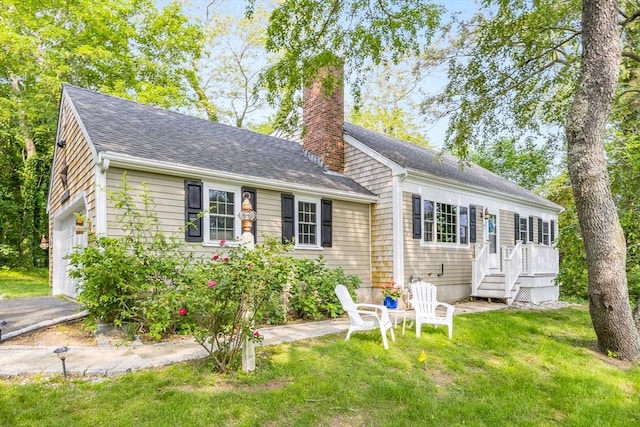 7 Liberty Pl, Dennis, MA 02660 - view of front of house featuring a chimney, a front lawn, and a shingled roof