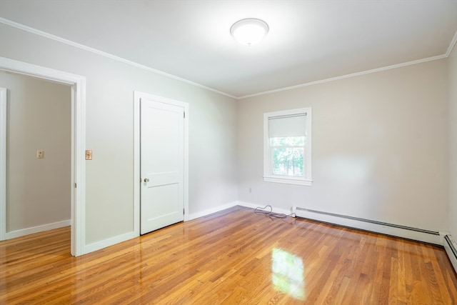 unfurnished room featuring light hardwood / wood-style floors, crown molding, and a baseboard radiator