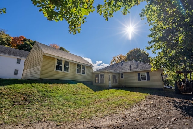 rear view of property with a lawn