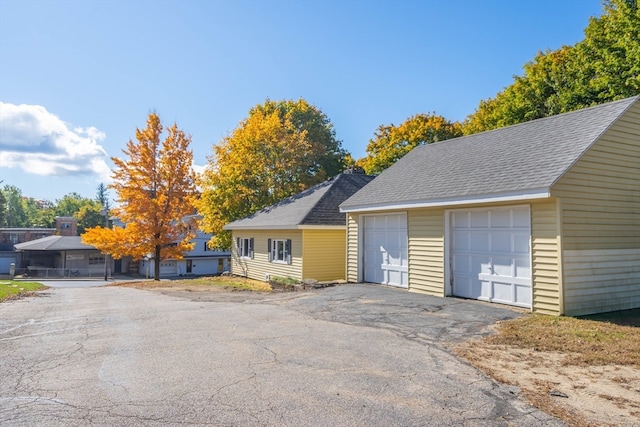 view of front of property featuring a garage and an outbuilding