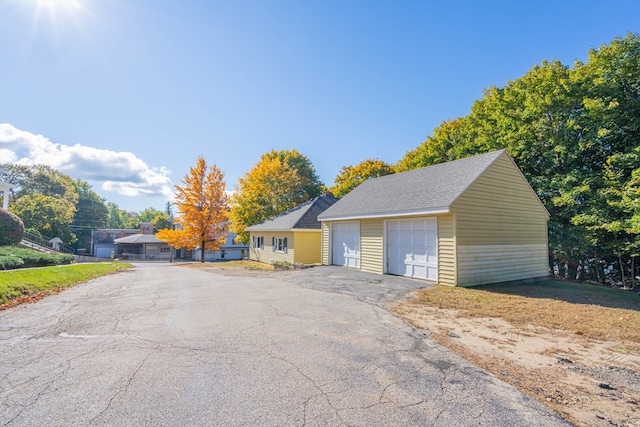 view of front of home featuring a garage and an outdoor structure