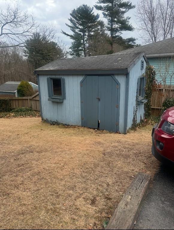 view of shed featuring fence