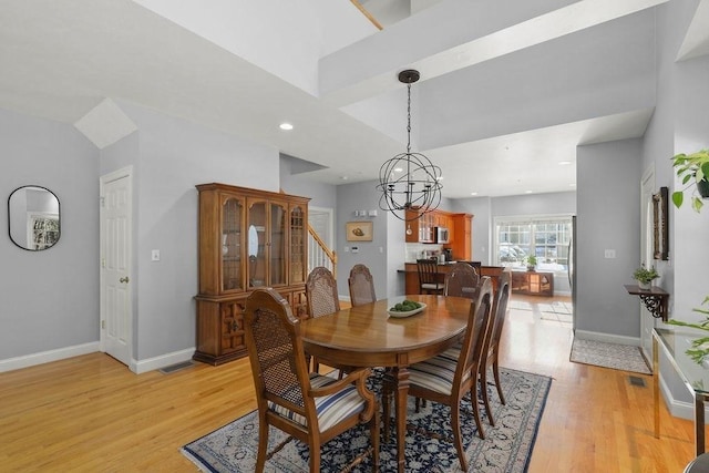 dining area featuring a chandelier and light hardwood / wood-style flooring