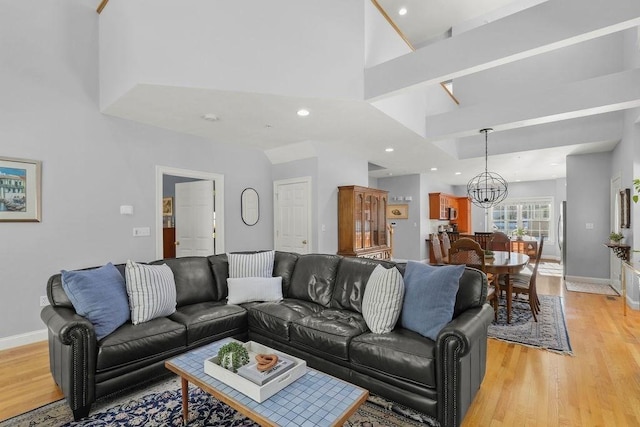 living room featuring an inviting chandelier and light hardwood / wood-style flooring