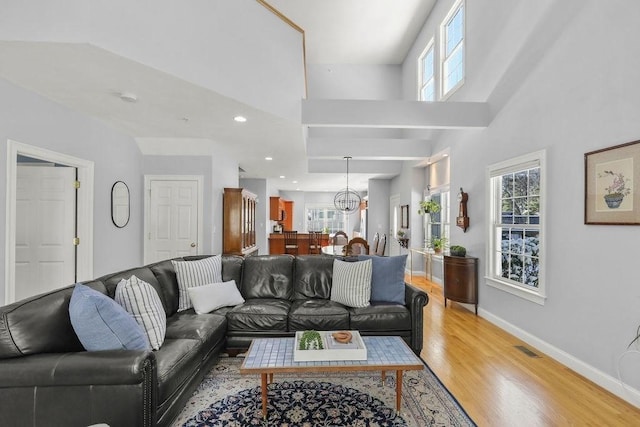 living room with a high ceiling and hardwood / wood-style floors