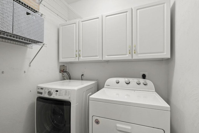 laundry area with cabinets and washing machine and dryer