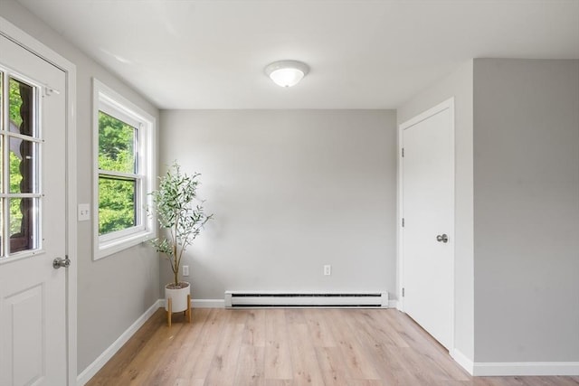 742 Daniel Shays Hwy Unit 1F, Athol, MA 01331 - unfurnished room featuring a baseboard radiator and wood finished floors