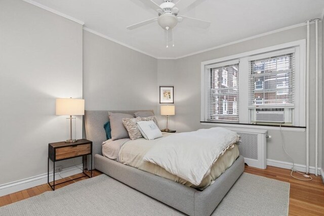 5 Arlington St Unit 31, Cambridge, MA 02140 - bedroom featuring baseboards, wood finished floors, crown molding, radiator heating unit, and a ceiling fan