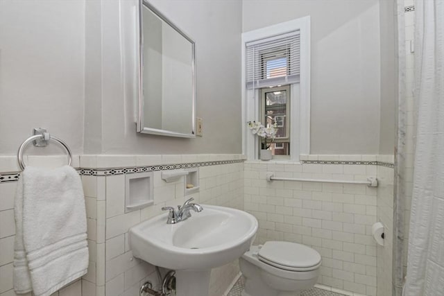 5 Arlington St Unit 31, Cambridge, MA 02140 - full bathroom featuring tile walls, a wainscoted wall, toilet, curtained shower, and a sink
