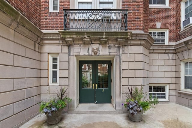 5 Arlington St Unit 31, Cambridge, MA 02140 - property entrance with french doors, brick siding, a balcony, and stone siding