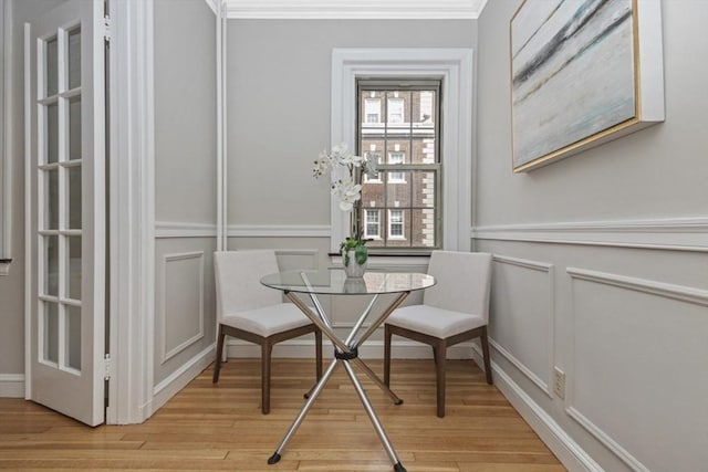 5 Arlington St Unit 31, Cambridge, MA 02140 - dining area featuring a decorative wall, light wood finished floors, ornamental molding, and a wainscoted wall
