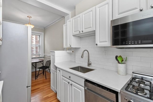 5 Arlington St Unit 31, Cambridge, MA 02140 - kitchen with stainless steel microwave, dishwashing machine, a sink, range, and light countertops