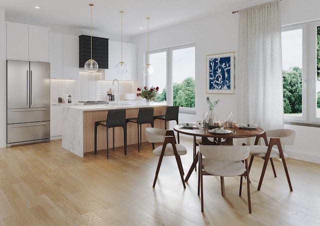 dining space with light wood finished floors and recessed lighting