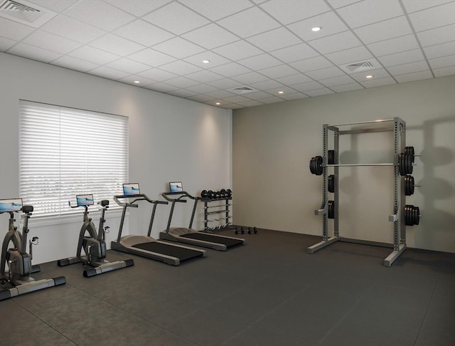 exercise room featuring a paneled ceiling, visible vents, and recessed lighting