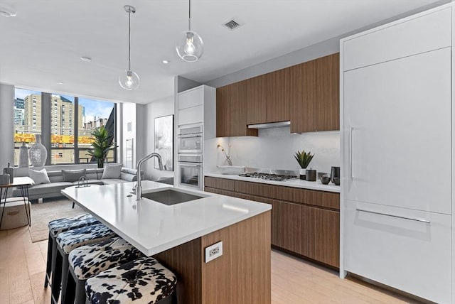 kitchen with a view of city, light countertops, brown cabinets, and white cabinets