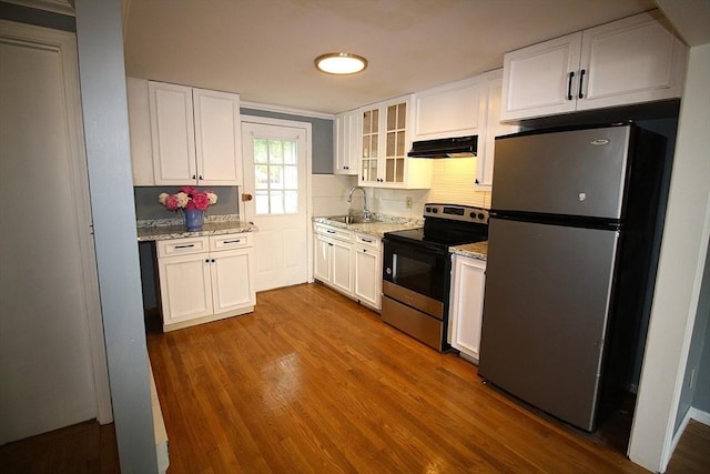 17 Fairland St Unit 17, Boston, MA 02119 - kitchen featuring appliances with stainless steel finishes, under cabinet range hood, a sink, white cabinetry, and dark wood-style floors