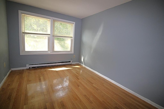 17 Fairland St Unit 17, Boston, MA 02119 - spare room featuring baseboard heating, light wood-style flooring, and baseboards