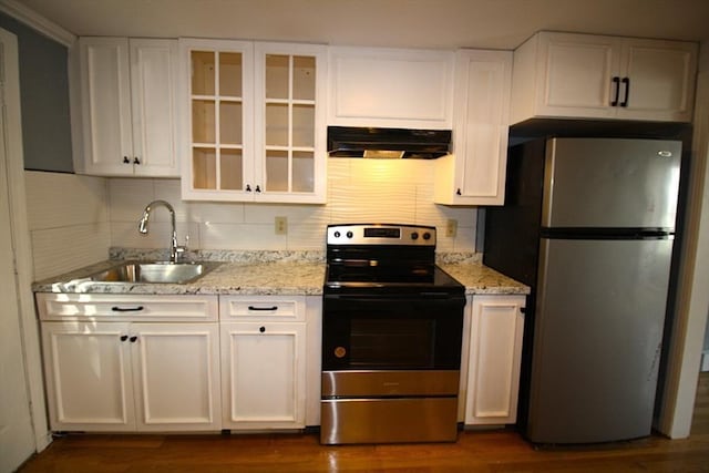 17 Fairland St Unit 17, Boston, MA 02119 - kitchen with appliances with stainless steel finishes, under cabinet range hood, white cabinetry, and decorative backsplash