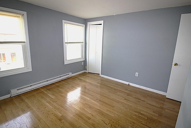 17 Fairland St Unit 17, Boston, MA 02119 - empty room featuring a baseboard radiator, wood finished floors, and baseboards