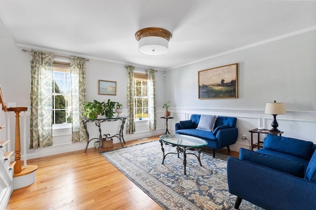 living room with plenty of natural light, stairs, and ornamental molding