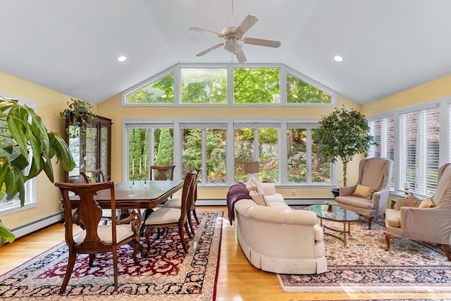 sunroom / solarium featuring lofted ceiling, wood finished floors, a baseboard radiator, baseboard heating, and recessed lighting