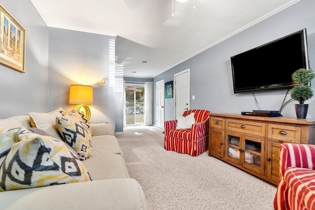 living area with light colored carpet, a ceiling fan, and crown molding