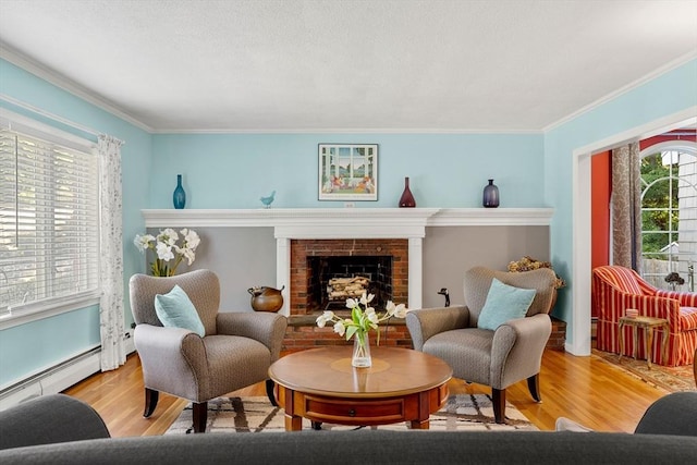 sitting room with wood finished floors, crown molding, a brick fireplace, and a baseboard radiator