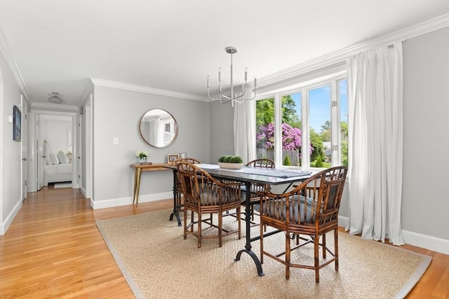56 Postgate Rd, Hamilton, MA 01982 - dining space featuring crown molding, a chandelier, light wood-style floors, and baseboards
