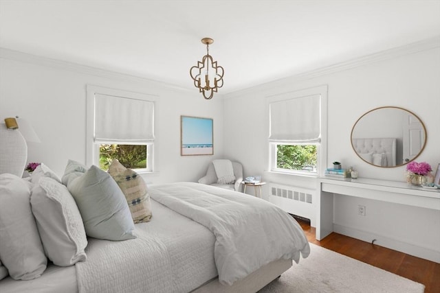 56 Postgate Rd, Hamilton, MA 01982 - bedroom with radiator heating unit, crown molding, wood finished floors, a chandelier, and baseboards