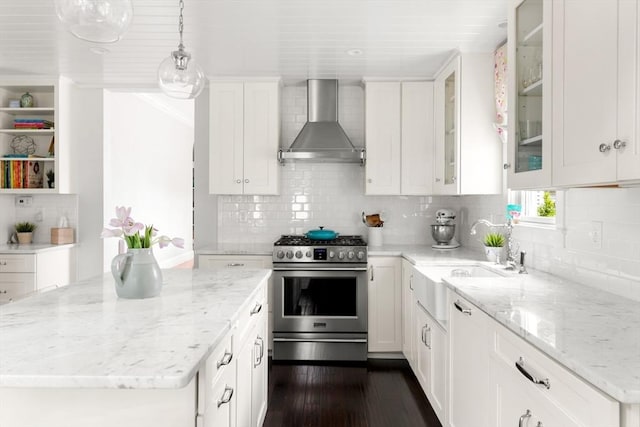 56 Postgate Rd, Hamilton, MA 01982 - kitchen with wall chimney exhaust hood, gas stove, white cabinets, dark wood finished floors, and tasteful backsplash