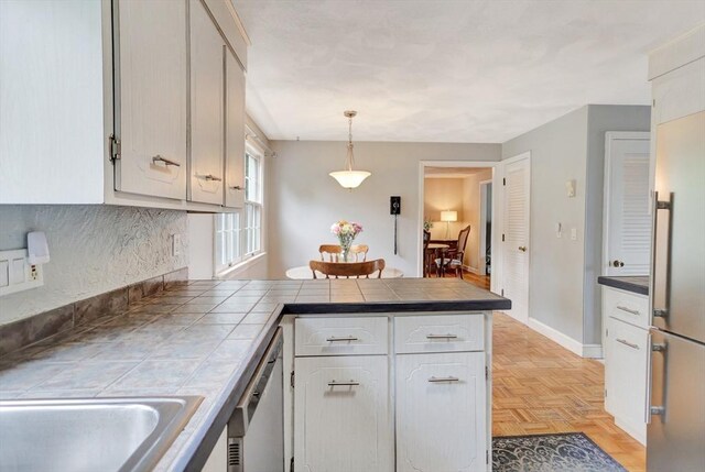 10 Emile Cir, Malden, MA 02148 - kitchen featuring a peninsula, tile countertops, white cabinetry, and stainless steel appliances