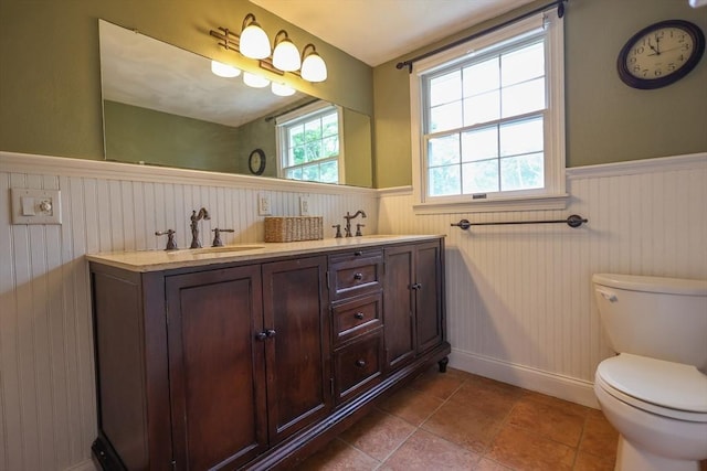 10 Emile Cir, Malden, MA 02148 - bathroom featuring wainscoting, double vanity, toilet, and baseboards