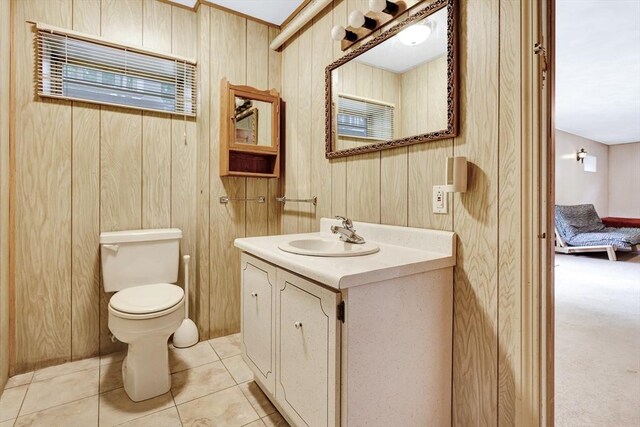 10 Emile Cir, Malden, MA 02148 - bathroom featuring vanity, toilet, wooden walls, and tile patterned floors