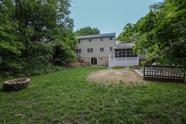 10 Emile Cir, Malden, MA 02148 - rear view of house featuring a fire pit, a sunroom, a yard, stairway, and a wooden deck