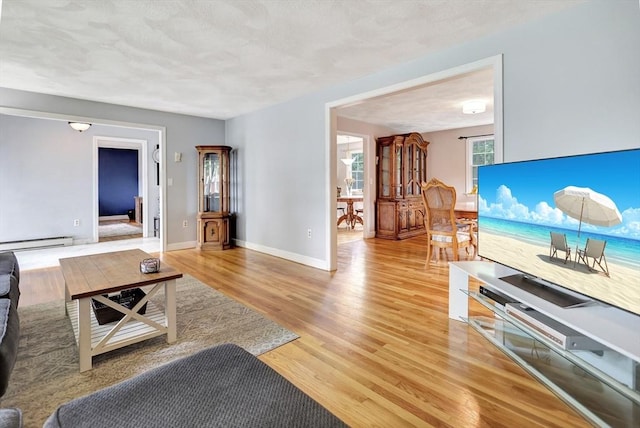 10 Emile Cir, Malden, MA 02148 - living area with baseboard heating, light wood-style flooring, and baseboards
