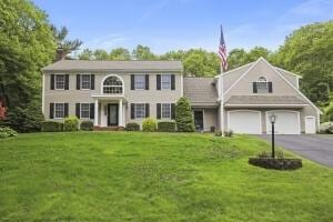 5 Lancaster Ln, Bourne, MA 02532 - colonial inspired home with a front yard, driveway, and a chimney