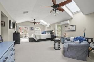 5 Lancaster Ln, Bourne, MA 02532 - carpeted bedroom with a wall mounted air conditioner, vaulted ceiling, and a skylight
