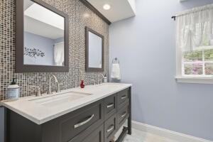 5 Lancaster Ln, Bourne, MA 02532 - bathroom with double vanity and decorative backsplash