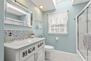 5 Lancaster Ln, Bourne, MA 02532 - bathroom with vanity, decorative backsplash, and combined bath / shower with glass door