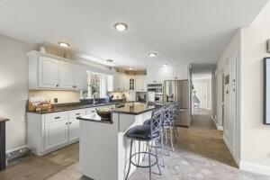 5 Lancaster Ln, Bourne, MA 02532 - kitchen with a breakfast bar, dark countertops, a center island, stainless steel fridge, and recessed lighting