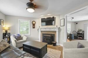 5 Lancaster Ln, Bourne, MA 02532 - living room featuring a fireplace and a ceiling fan
