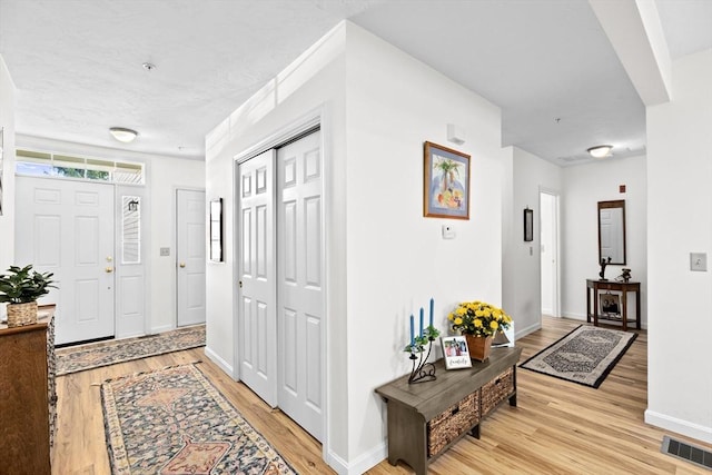 foyer with light wood-type flooring