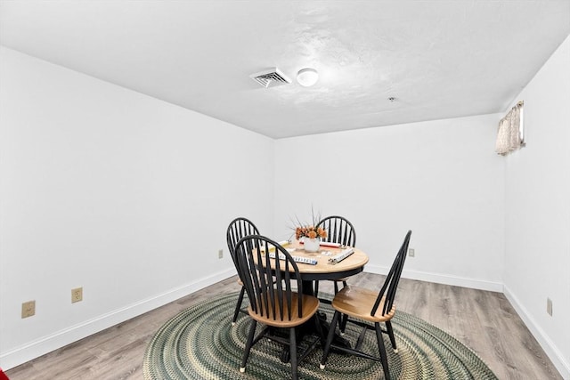 dining area featuring light wood-type flooring