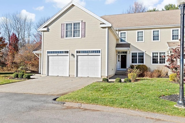 view of front property with a front yard and a garage