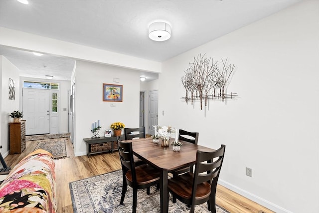 dining space with light hardwood / wood-style flooring