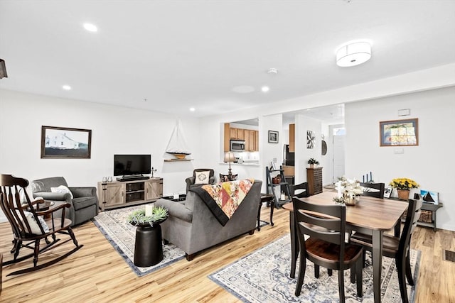 living room with light hardwood / wood-style flooring