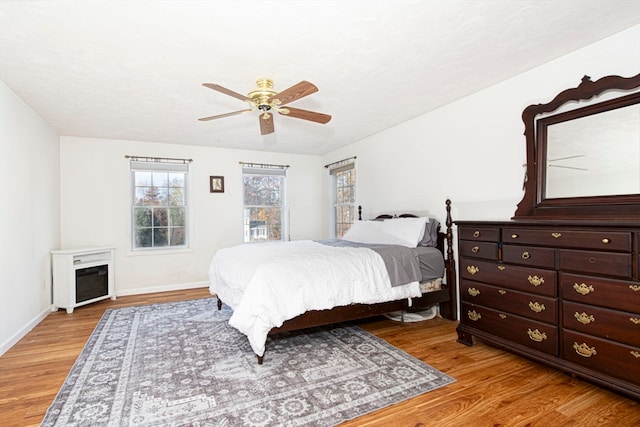 bedroom with light hardwood / wood-style flooring and ceiling fan