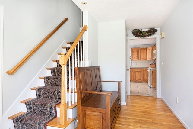 stairs with hardwood / wood-style floors