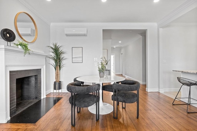 dining room featuring ornamental molding, an AC wall unit, and hardwood / wood-style floors