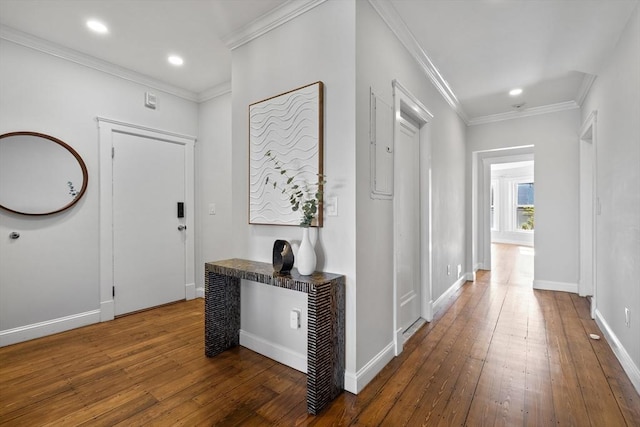 hallway with baseboards, ornamental molding, hardwood / wood-style floors, and recessed lighting